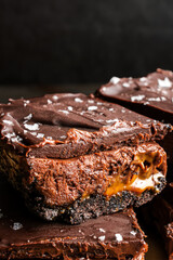 Caramel Chocolate Cheesecake Dessert Bars with Ganache Topping: Layers of chocolate crust, caramel, cheesecake filling, and dark chocolate ganache
