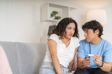 Nervous couple waiting for the results of a pregnancy test