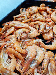 Chilled boiled shrimp in a supermarket or grocery store, close-up. Seafood