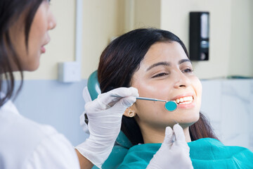 Asian Dentist Checking up on her patient, Female dentist and Female Patient in a Hospital