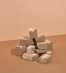 Lots of cardboard boxes on a beige background. Moving or relocation concept.