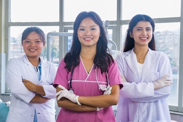 Confident Group of Nepali Indian Nurse and Doctors Smiling with hands crossed in a Dental Hospital