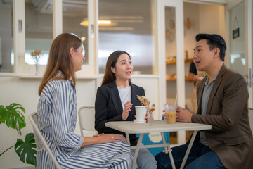 Group Business People Chatting Balcony Concept. Business people talking during coffee break. A cheerful friendly group of multicultural colleagues is sitting at the office and having coffee break.