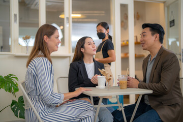 Group Business People Chatting Balcony Concept. Business people talking during coffee break. A cheerful friendly group of multicultural colleagues is sitting at the office and having coffee break.