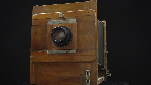 Rotating Direct Viewing Retro Camera On A Black Background.