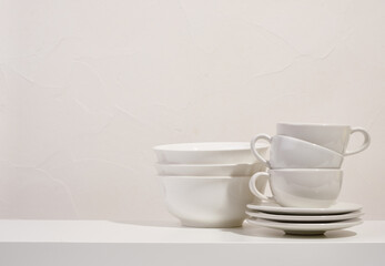 Clean washed dishes white color on the table. Copy space for text.