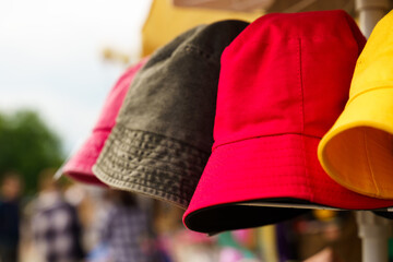 Multi-colored Panama hats on the counter of a trade tent at a fair.
