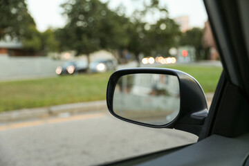 car's rearview mirror, reflecting a scenic road behind. The mirror symbolizes nostalgia, reflection, and the journey of life, capturing moments from the past