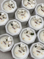 White concrete votive candles decorated with small heart fondants and dried flowers. Saint Valentine Or Wedding candles.