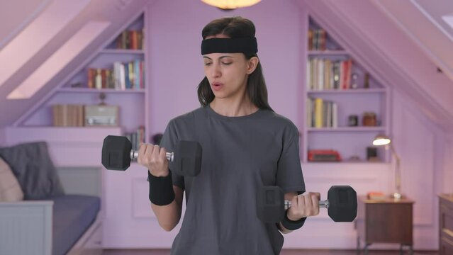 Indian woman lifting heavy dumbbells weight