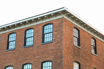 brick building with arched windows, symbolizing stability and growth in the business and mortgage industry, a hub of commerce