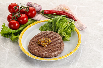 Frilled beef burger cutlet with iceberg