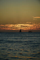 Sunrise background. Sunset over sea with golden dramatic sky panorama. Calm sea with sunset sky. Ocean and sky background.