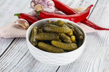 Marinated small cucumbers in the bowl