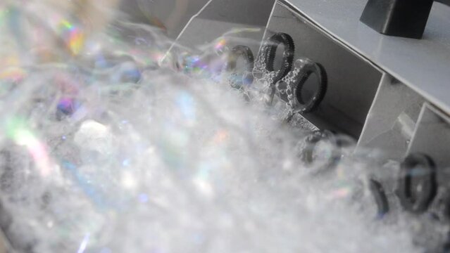 Soap bubble generator close up. Working operation Soap Bubble Generator and inflating soap bubbles. Bubble machine. Automatic blowing soap bubbles. Creating bubbles. Entertainment, celebration, party