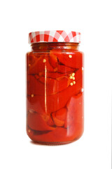 Preserved red peppers in jar isolated on white background. Fall home food preserving.