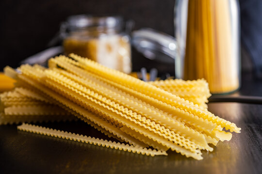 Mafaldine pasta. Uncooked italian pasta on black table.