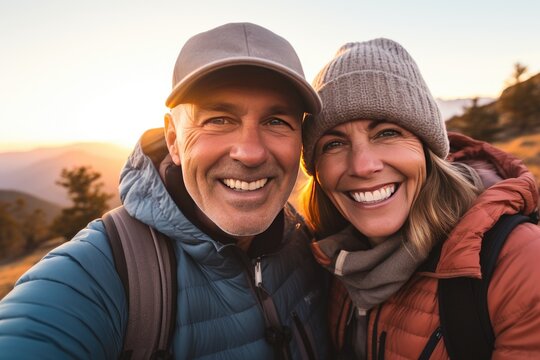 Senior couple hiking. Smiling and happy senior man and woman taking a selfie on their trip.