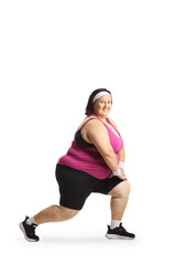 Fototapeta premium Corpulent woman in sportswear stretching knees