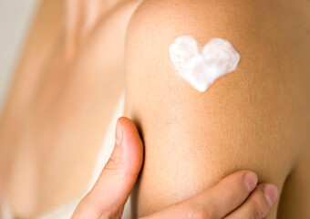 Woman gently cares for her body.