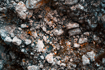 Textured rock, white and gray stones with orange moss in the mountains.
