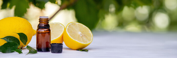 lemon oil in jars, fresh lemon. Selective focus.