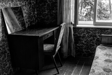 Work table in an old house near the window, black and white - obrazy, fototapety, plakaty