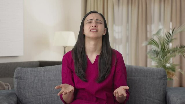 Disappointed Indian woman slapping her head