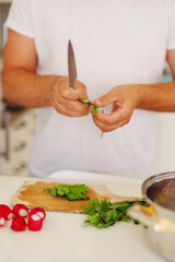 chef man prepare food at home cutting vegetables for soup Kholodnik