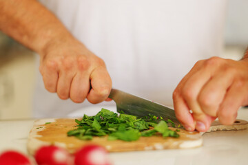 chef man prepare food at home cutting vegetables for soup Kholodnik