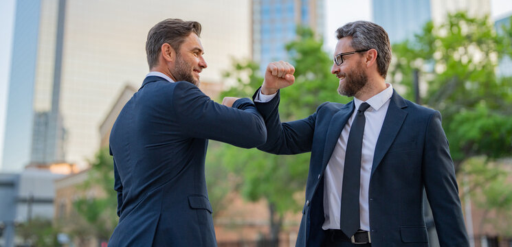 Businessman Handshake With Partner. Two Businessmen Shaking Hands On City Street. Business Men In Suit Shaking Hands Outdoors. Handshake Between Two Businessmen.