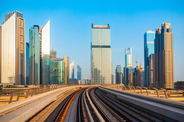 Fototapeta na wymiar Dubai Metro and city skyline, UAE