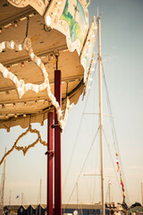 Detail of a vintage carousel at Paimpol touristic port. Toned, vintage filtered image, vertical...