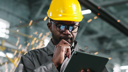 Man in glasses is calculating something on his gadget and is seriously thinking about something....