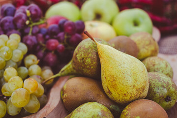 Still life of green pears and green and purple grapes