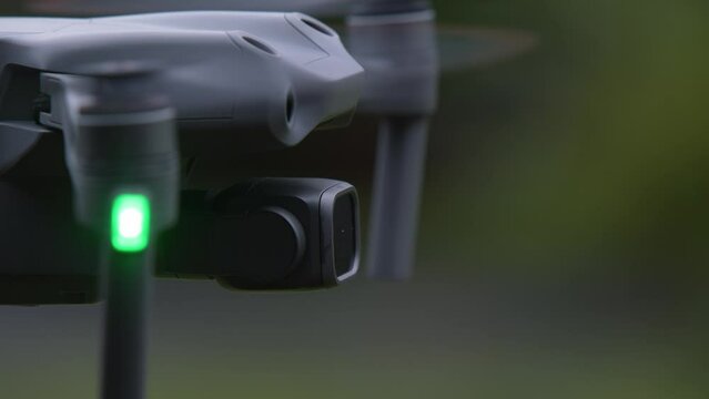 Abstract Closeup View of Hovering Drone outdoor, green nature background. High quality 4k footage