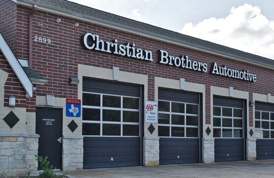 Christian Brothers Automotive Workshop Exterior And Garage Doors In Houston, TX. Auto Repair Business Chain Est. 1982.