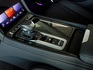 Naklejka premium Automatic gear stick of a modern car. Modern car interior details. Close up view. Car detailing. Automatic transmission lever shift