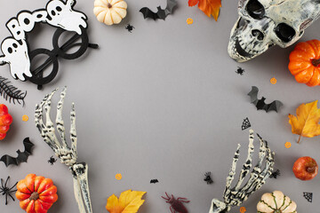 Delighting in the strange and captivating allure of Halloween. Top view of skull, skeleton hands,...