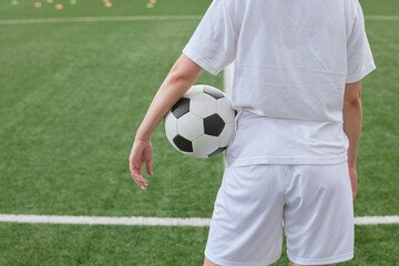 sports girl football player with a soccer ball on the soccer field, the concept of professional women's football