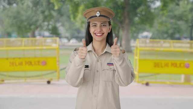 Happy Indian female police officer doing Thumbs up