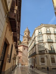 Fototapeta na wymiar Catedral de la Encarnación de Málaga between an alley