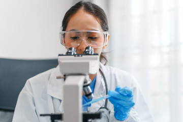 Young scientists pioneering medical discoveries in lab, with one scientist employing microscope for invaluable insights, blood lab test, virus vaccine invent, asian indian people