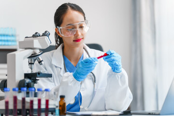Young scientists pioneering medical discoveries in lab, with one scientist employing microscope for invaluable insights, blood lab test, virus vaccine invent, asian indian people