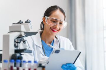 Young scientists pioneering medical discoveries in lab, with one scientist employing microscope for invaluable insights, blood lab test, virus vaccine invent, asian indian people