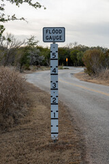 Flood Gauge Stands Tall Next To Low Laying Road