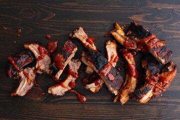 Korean Gochujang Baby Back Ribs on a Wood Background: Pork loin ribs cooked in hot and spicy Korean...