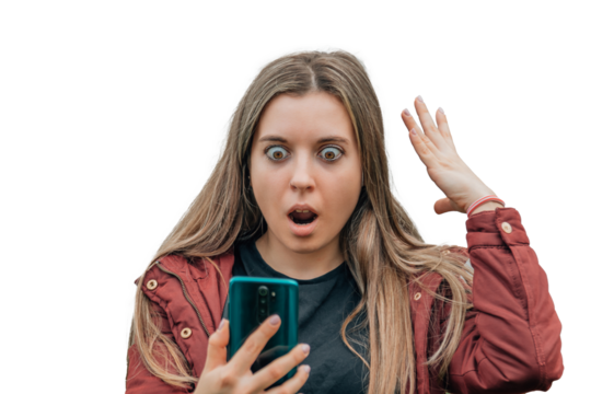 girl with surprised expression looking at the cell phone or mobile phone in the street