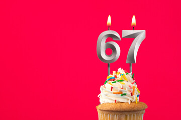 Burning candle number 67 - Birthday card with cake