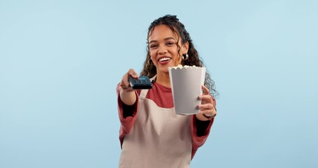 Waitress woman, machine and payment in studio, popcorn and smile on face with service by blue background. Girl, cinema employee and fintech for pos transaction for fast food, snack and catering job